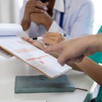 People analyzing a report following a request for medical assessment